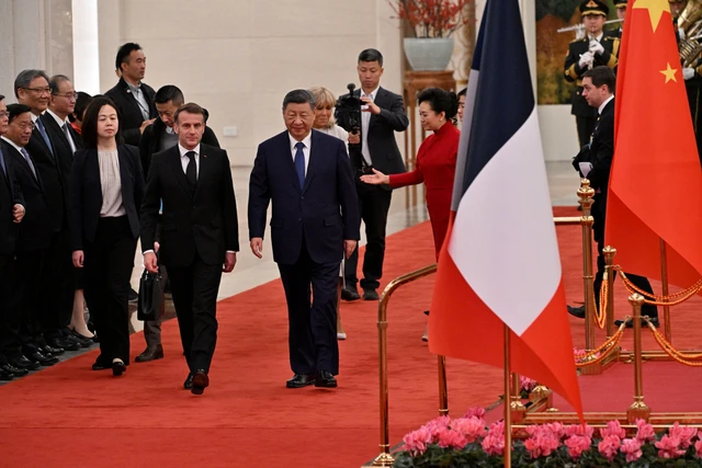Presiden China Xi Jinping menyambut kedatangan Presiden Prancis Emmanuel Macron sebelum pertemuan di Beijing, China, Kamis (4/12/2025). Foto: Adek Berry/Pool via REUTERS