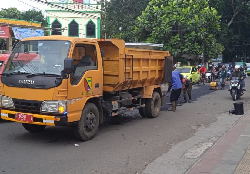 Dinas Pekerjaan Umum dan Penataan Ruang (PUPR) melakukan penambalan aspal jalan berlubang di Alun-alun Soreang, Kabupaten Bandung. FOTO: Supri07/portalbmi.id